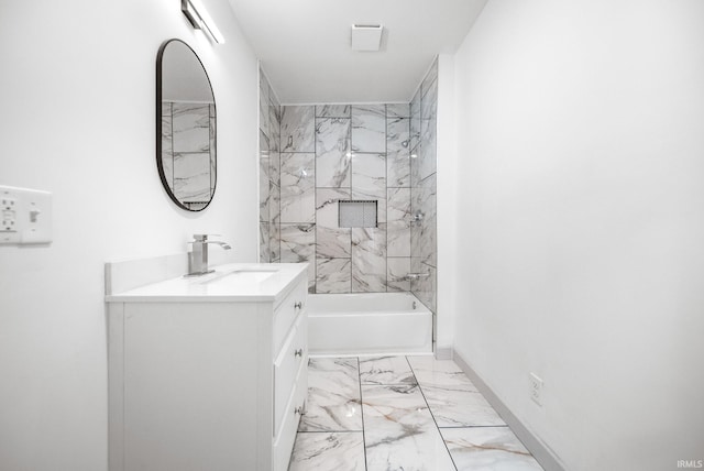 bathroom featuring marble finish floor, baseboards, tub / shower combination, and vanity