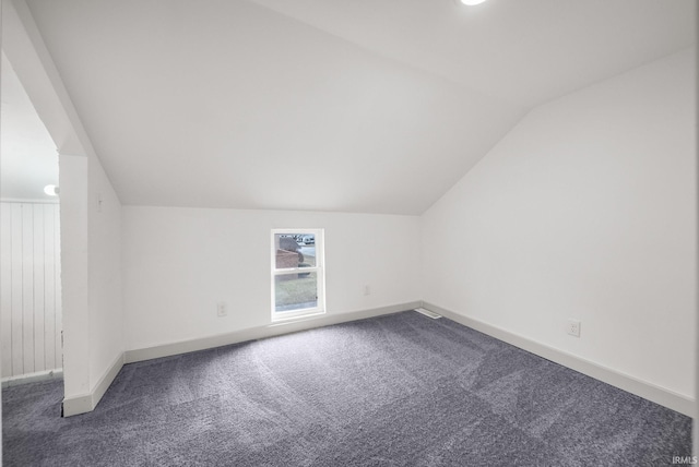 additional living space featuring lofted ceiling, baseboards, and carpet floors