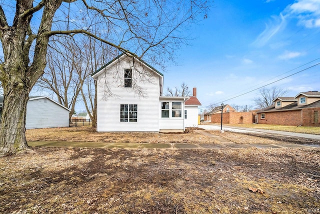 back of property with a chimney