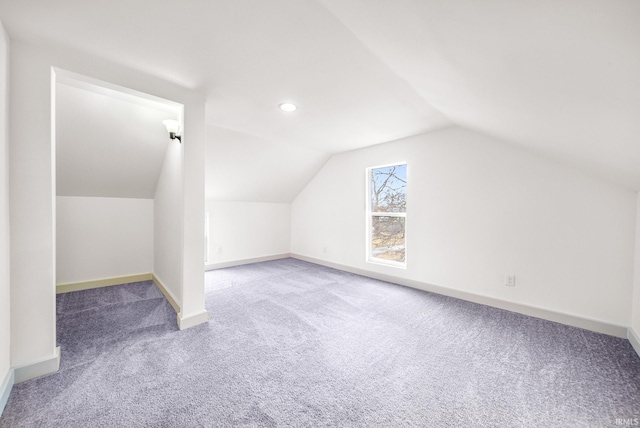 bonus room featuring vaulted ceiling, carpet flooring, and baseboards