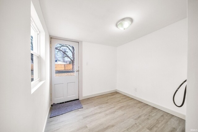 interior space featuring baseboards and wood finished floors