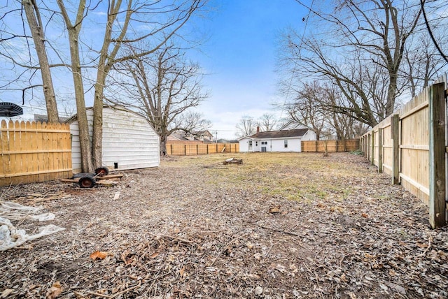 view of yard with an outdoor structure and a fenced backyard