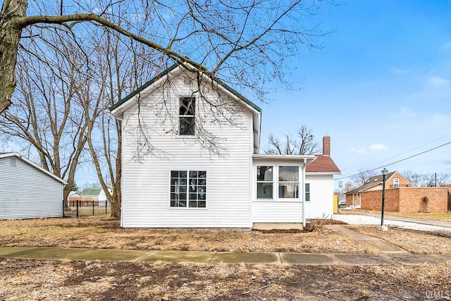 back of house with fence