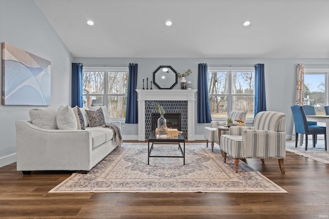 living area featuring wood finished floors, a tile fireplace, and recessed lighting