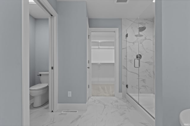 bathroom with a marble finish shower, visible vents, toilet, marble finish floor, and a spacious closet