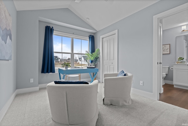 sitting room with lofted ceiling, baseboards, and carpet flooring