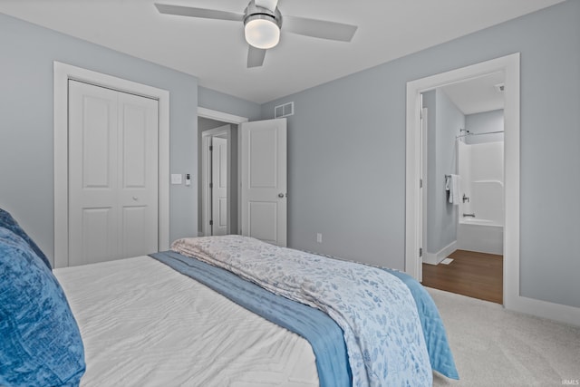 bedroom with carpet floors, a closet, visible vents, ceiling fan, and baseboards