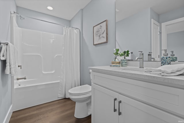 full bath featuring shower / bath combo with shower curtain, vanity, toilet, and wood finished floors