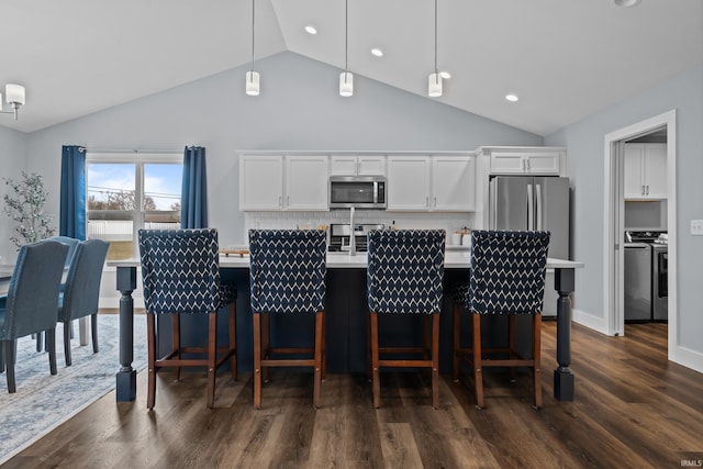 kitchen with stainless steel appliances, separate washer and dryer, light countertops, and white cabinetry