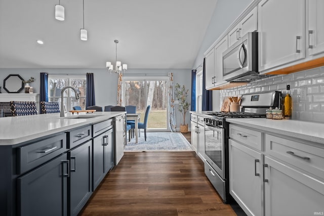 kitchen featuring stainless steel appliances, tasteful backsplash, a sink, and light countertops