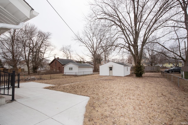 view of yard featuring an outbuilding and fence private yard