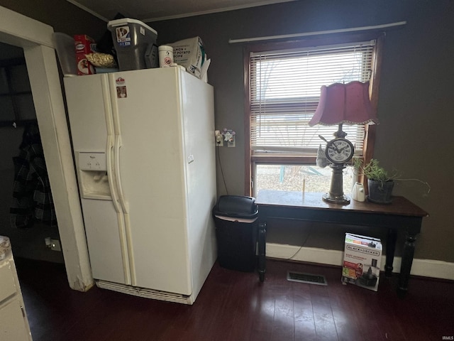 kitchen with white refrigerator with ice dispenser, visible vents, plenty of natural light, and wood finished floors