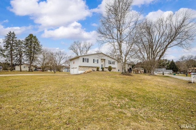 view of front of home featuring a garage and a front lawn