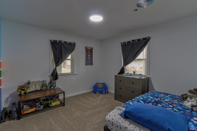 carpeted bedroom with multiple windows and baseboards