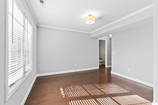 spare room with hardwood / wood-style flooring, baseboards, and ornamental molding