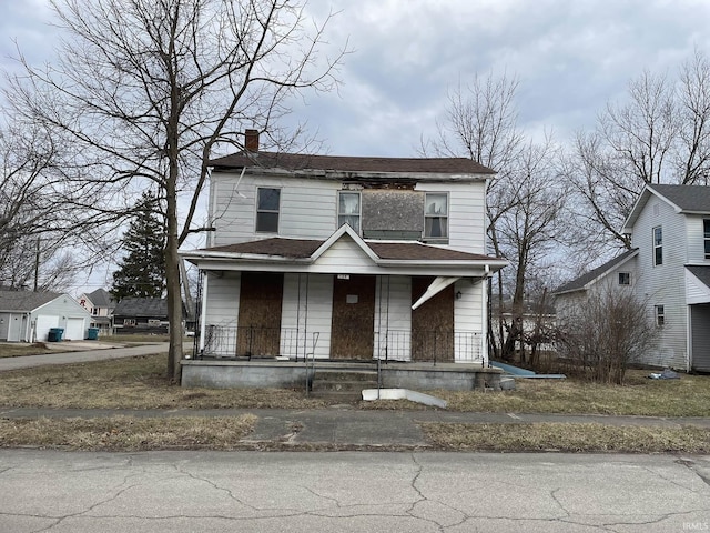 view of front of home featuring a porch and a chimney