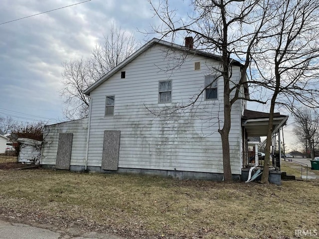 view of side of home with a chimney