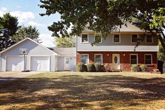 colonial-style house featuring an attached garage, concrete driveway, and brick siding