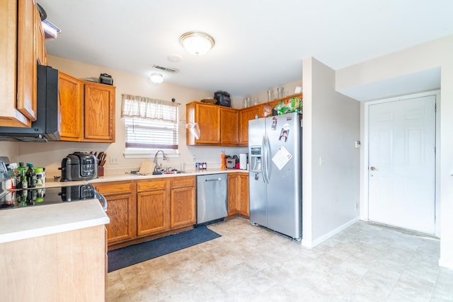 kitchen featuring a sink, visible vents, light countertops, appliances with stainless steel finishes, and light floors