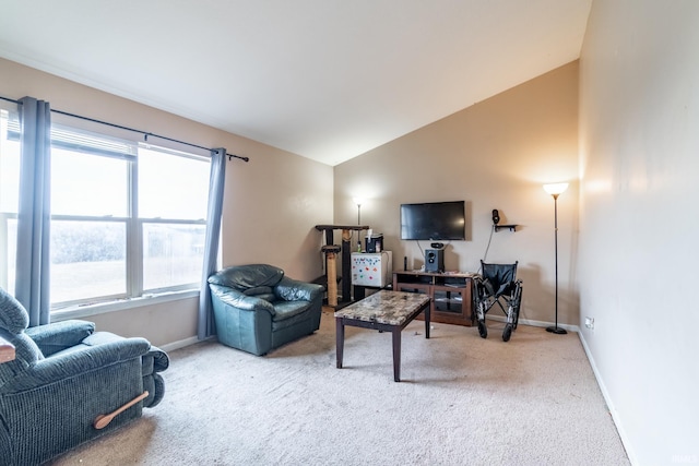 living room featuring lofted ceiling, carpet flooring, and baseboards