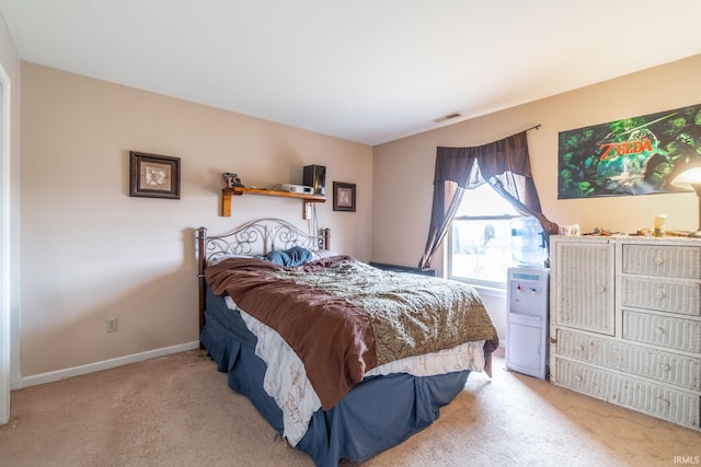 carpeted bedroom with visible vents and baseboards