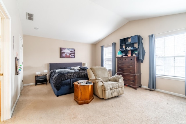 bedroom featuring light carpet, baseboards, visible vents, and vaulted ceiling