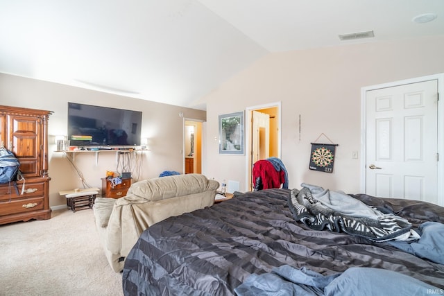 carpeted bedroom with visible vents and vaulted ceiling