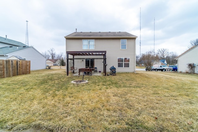 back of house with a fire pit, a lawn, fence, a patio area, and a pergola