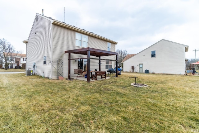 rear view of property featuring cooling unit, a patio area, a yard, and a fire pit