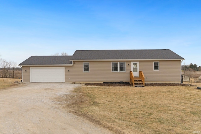 single story home featuring driveway, a garage, and a front lawn