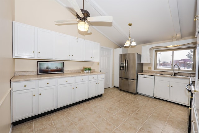 kitchen with lofted ceiling, a sink, white cabinetry, dishwasher, and stainless steel fridge