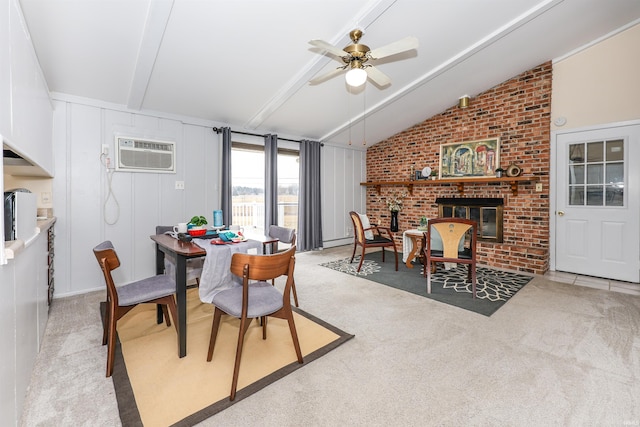 carpeted dining space with a ceiling fan, lofted ceiling with beams, a brick fireplace, a decorative wall, and a wall mounted AC