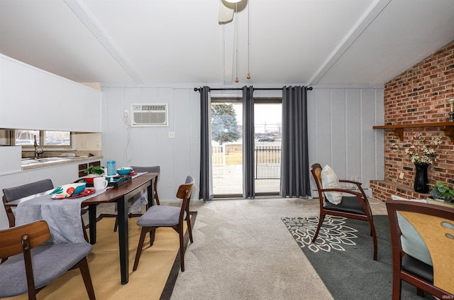 office area with a wall unit AC, light carpet, vaulted ceiling, and a wealth of natural light