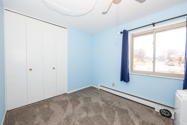 unfurnished bedroom with a ceiling fan, carpet, a closet, and baseboard heating