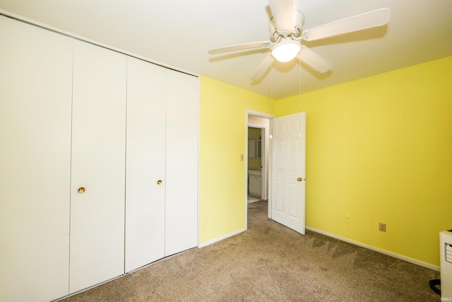 unfurnished bedroom with carpet floors, a closet, a ceiling fan, and baseboards