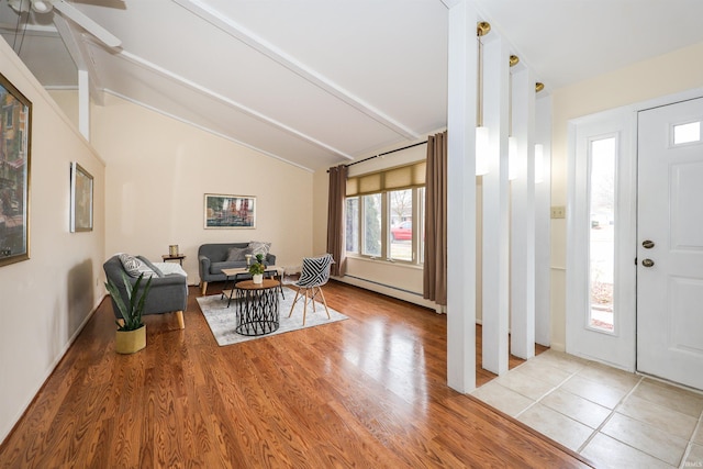 foyer featuring a baseboard radiator, vaulted ceiling with beams, and light wood-style flooring