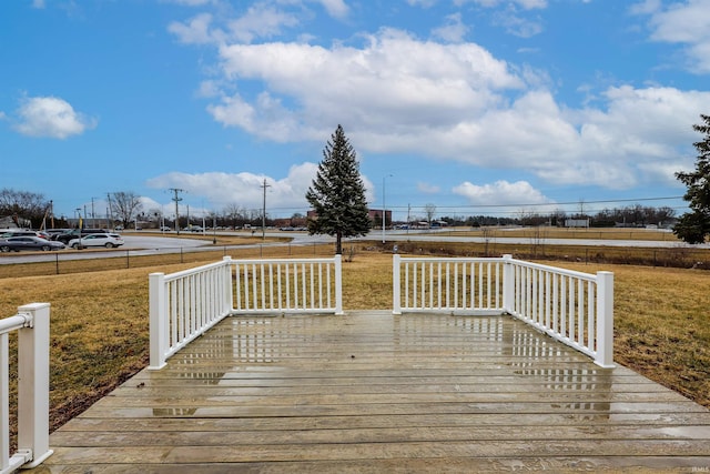 wooden deck featuring a yard