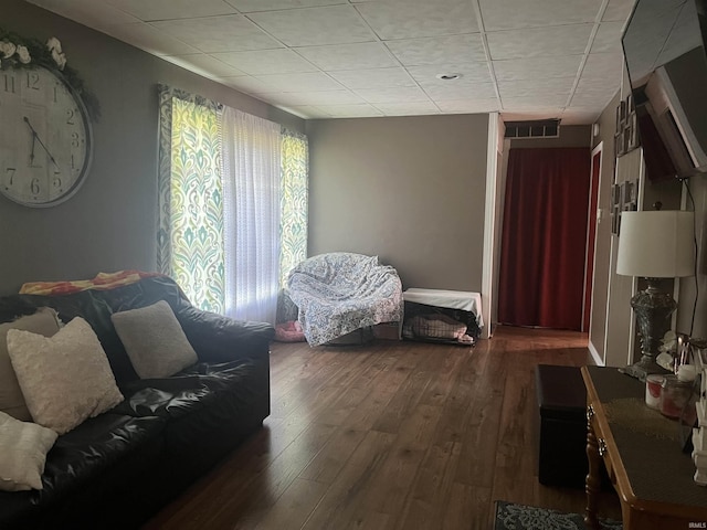 living area with wood-type flooring, visible vents, and a wealth of natural light