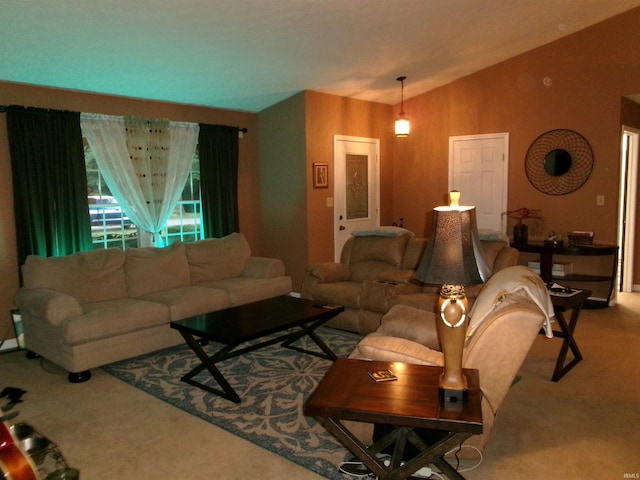 carpeted living room with lofted ceiling