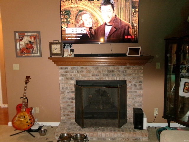 details featuring a fireplace and baseboards