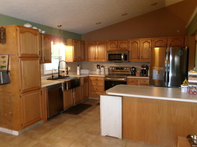 kitchen with stainless steel appliances, lofted ceiling, tasteful backsplash, light countertops, and a sink