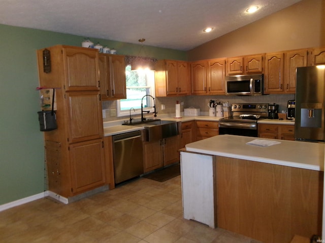 kitchen with tasteful backsplash, vaulted ceiling, stainless steel appliances, light countertops, and a sink