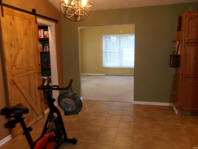 workout area featuring a chandelier, lofted ceiling, baseboards, and a barn door