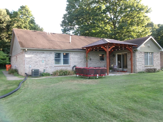 rear view of house featuring brick siding, a lawn, a patio area, cooling unit, and an outdoor living space