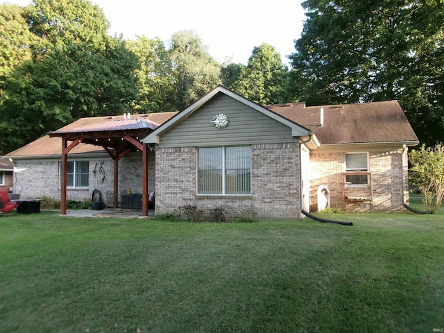 ranch-style house with brick siding, a front yard, and a gazebo