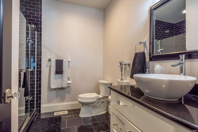 full bathroom with tile patterned flooring, vanity, visible vents, baseboards, and a stall shower