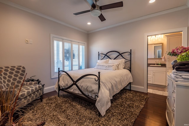 bedroom featuring dark wood-style flooring, crown molding, recessed lighting, a sink, and baseboards