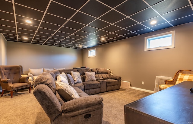 living area with plenty of natural light, carpet flooring, a paneled ceiling, and baseboards