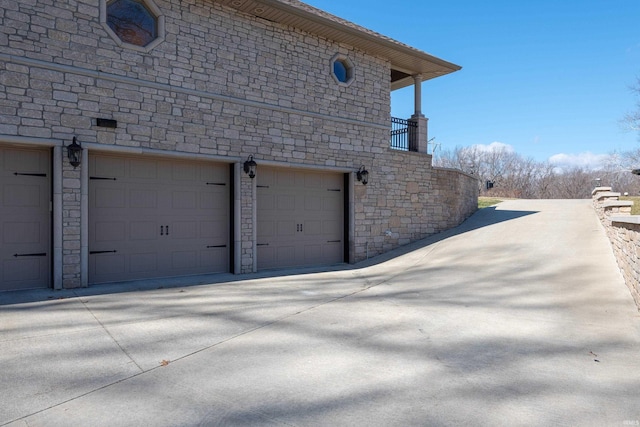 view of side of property with a garage and driveway