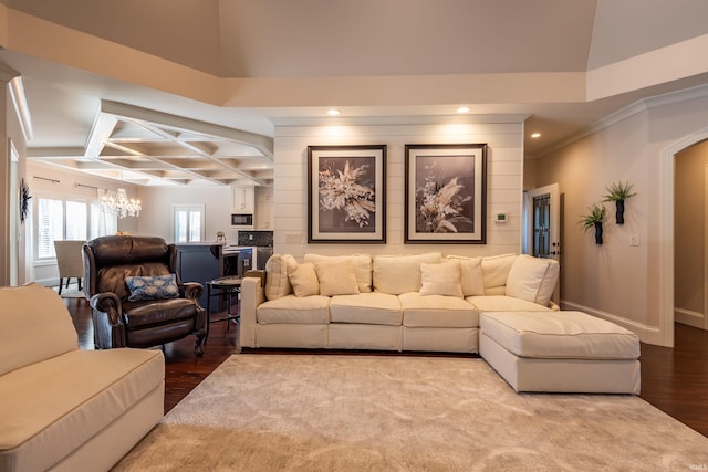 living area featuring arched walkways, a notable chandelier, wood finished floors, coffered ceiling, and baseboards